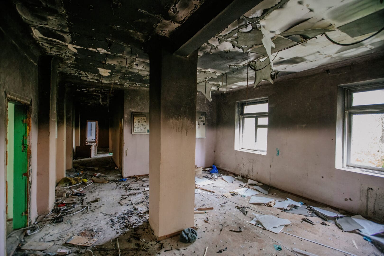 Fire-damaged building interior debris.
