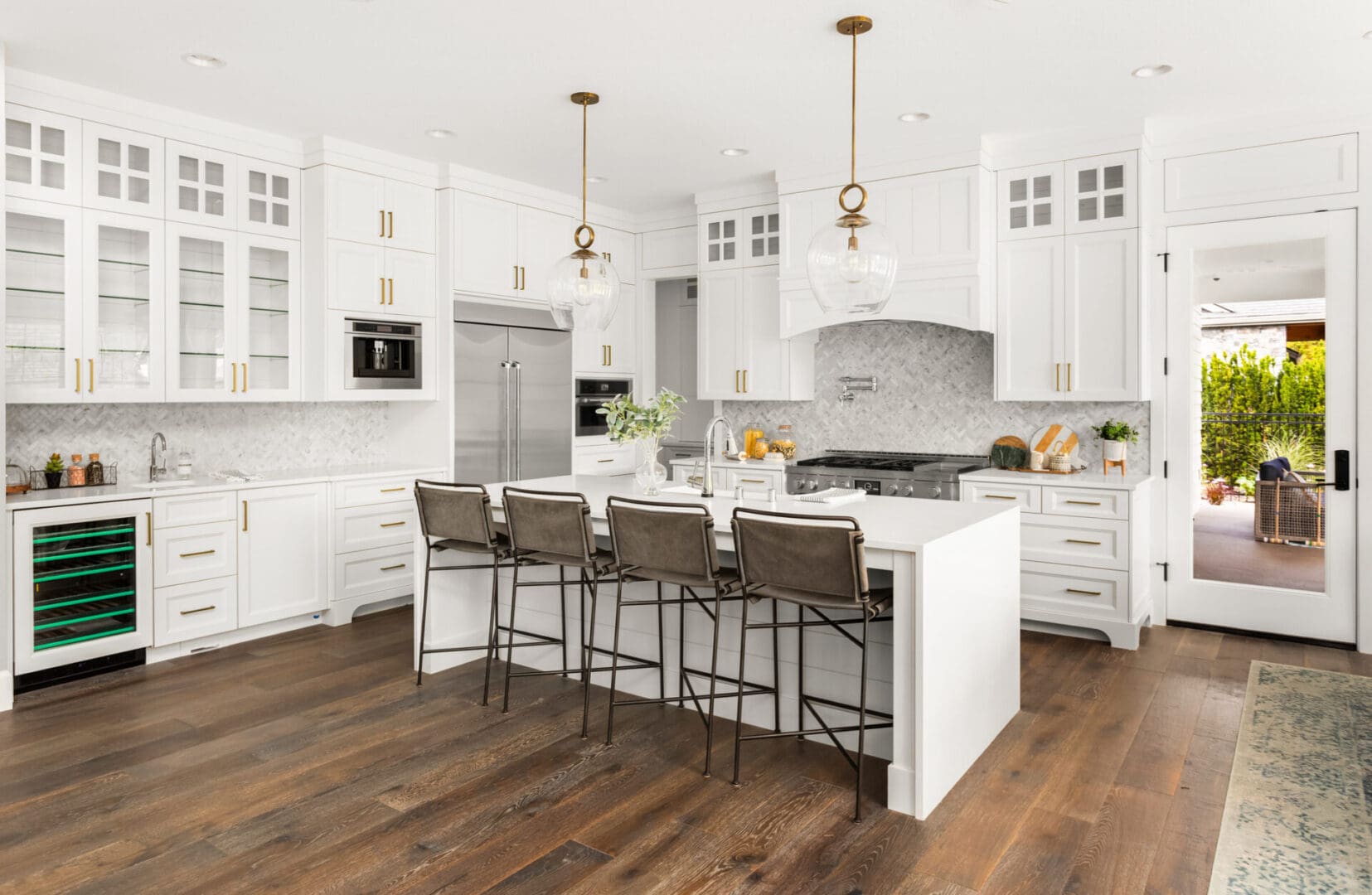 Modern white kitchen with island and seating.