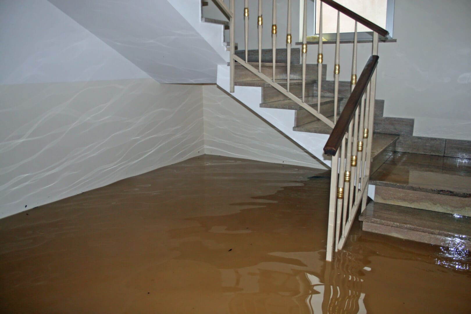 Flooded staircase, muddy water damage.