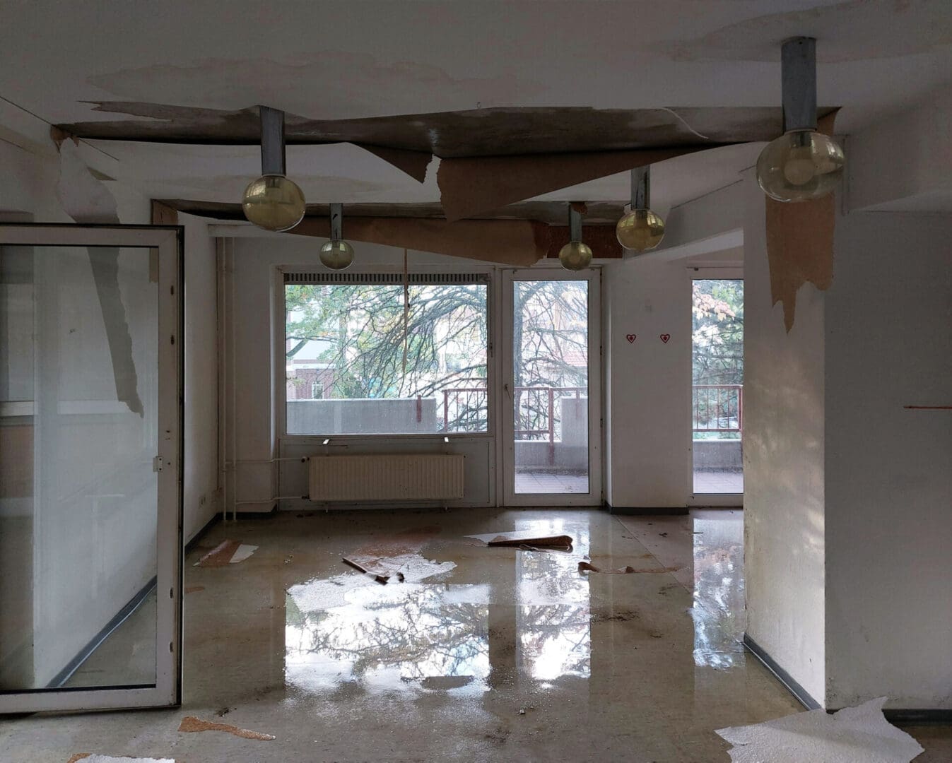 Flooded room with damaged ceiling.